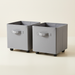 Two gray rolling foldable storage bins with handles and casters